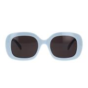Geometriske solbriller med blank blå ramme og grå organiske linser
